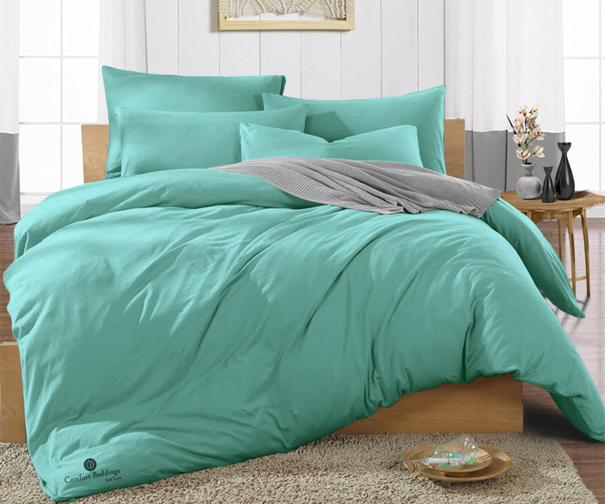 Aqua green duvet cover styled on a bed