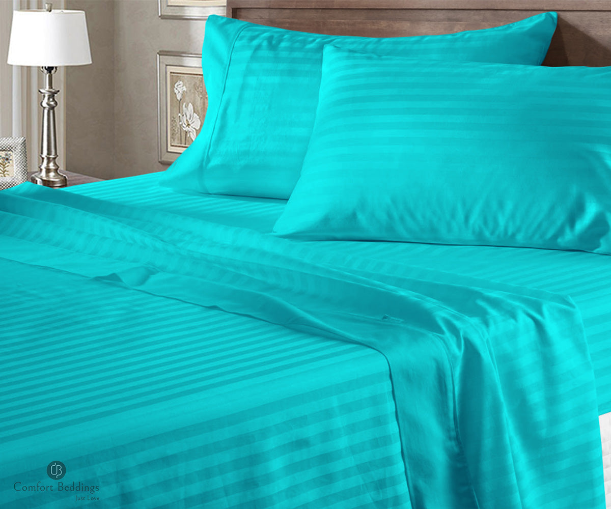 Cotton stripe bed sheets in turquoise blue on a neatly made bed