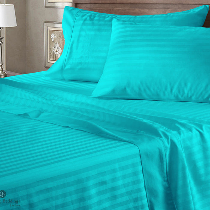 Cotton stripe bed sheets in turquoise blue on a neatly made bed
