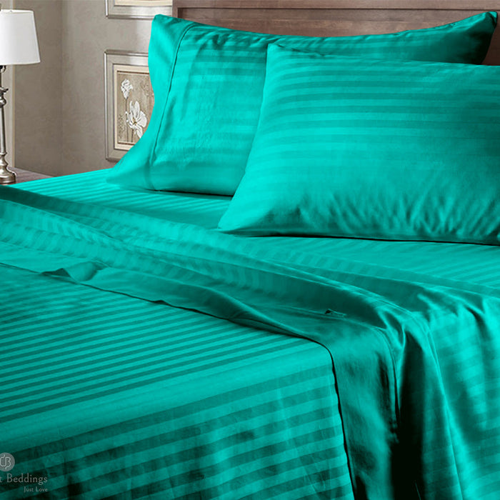 Neatly made bed with cotton bedding and pillows