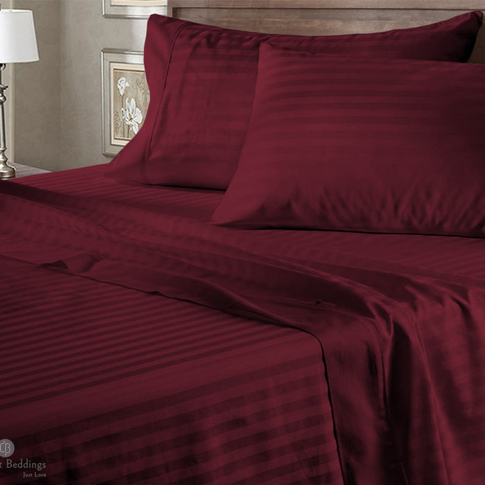 Wine stripe bed sheets neatly made on a bed