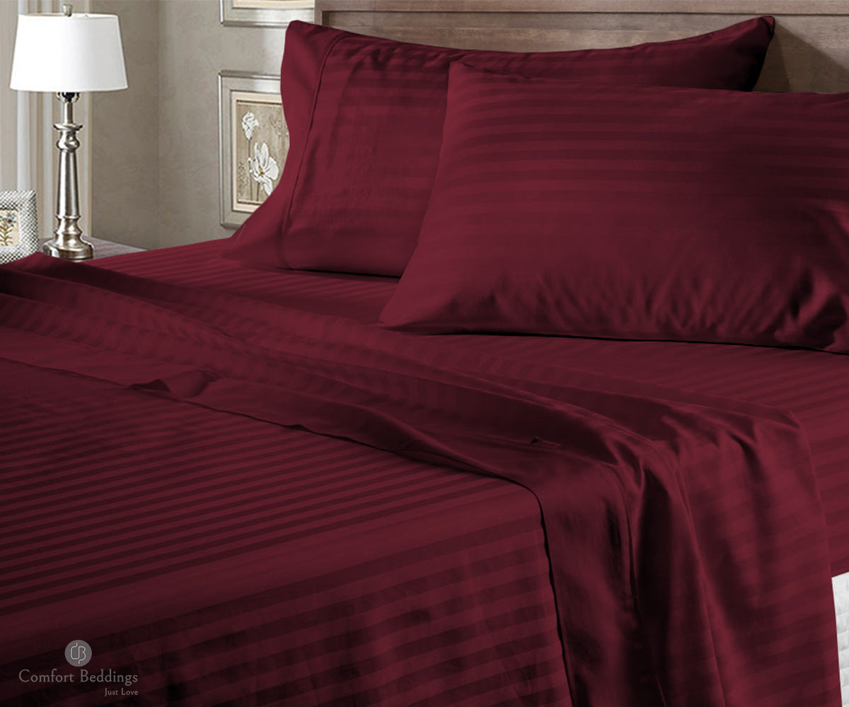 Wine coloured cotton stripe bed sheet styled on a bed